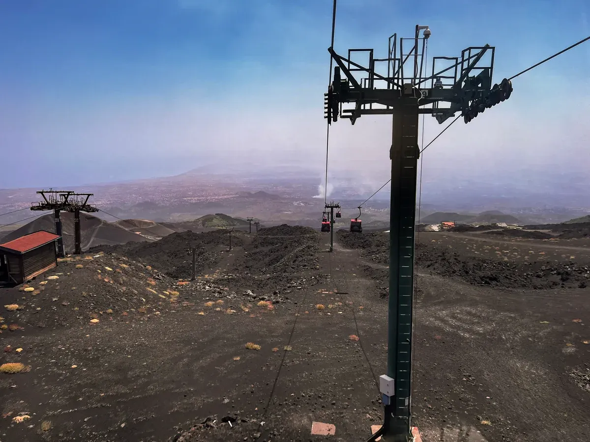 The Funivia dell'Etna cable car above the black lava slopes, an extra on many Mount Etna tours from Taormina, Sicily