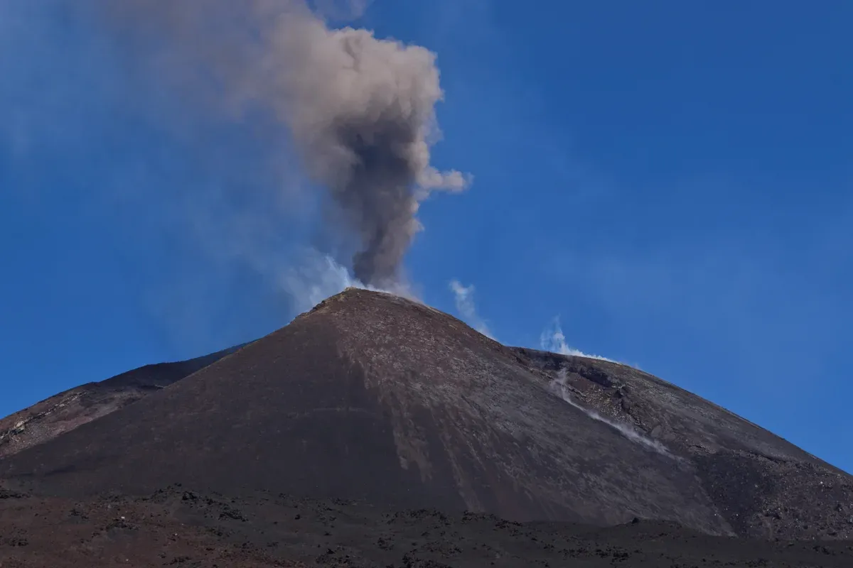 Etna's summit craters steaming under a blue sky, the goal of the 4x4 Mount Etna tours from Taormina, Sicily