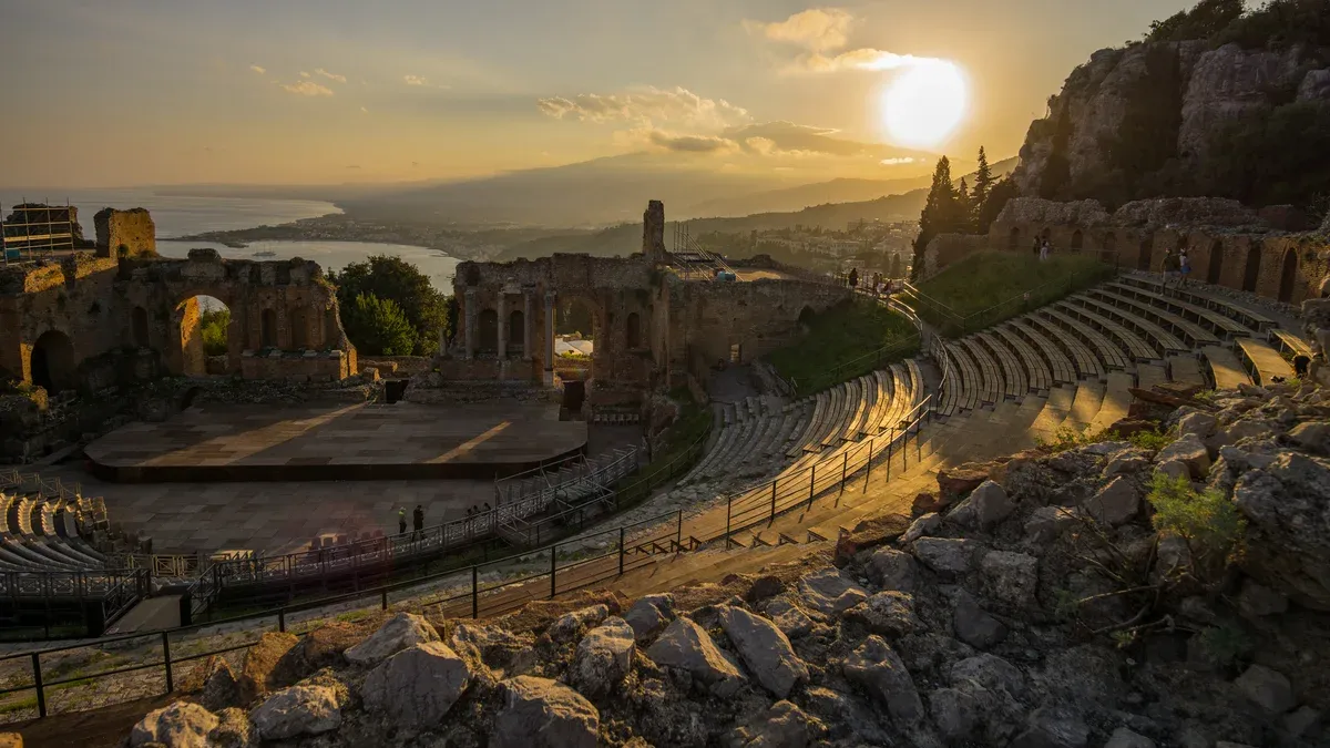 The Greek theatre of Taormina at sunset with Etna in the background, the start of every Mount Etna tour from Taormina, Sicily